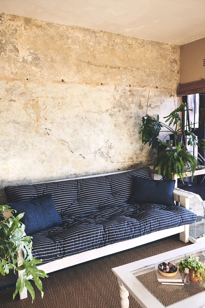 Interior design, couch or wall background of rustic apartment wi